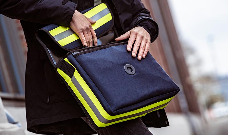 opened Lübeck messenger bag in use by person