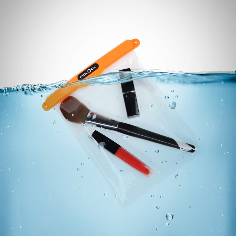 Example of the dry bag maxi in transparent and orange floating in water