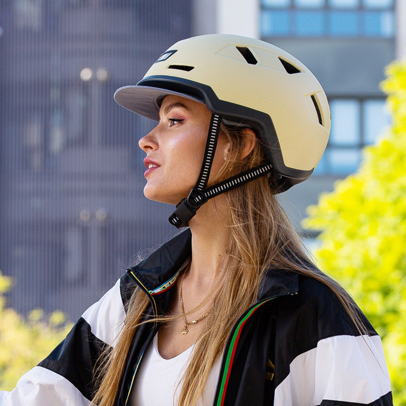 Headshot from the side of a woman wearing a Xnito helmet with FIDLOCK buckle