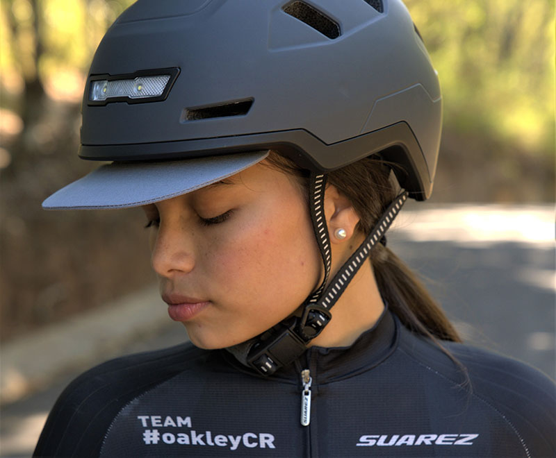 Woman with a dark Xnito helmet shot from the front - helmet buckle clearly visible