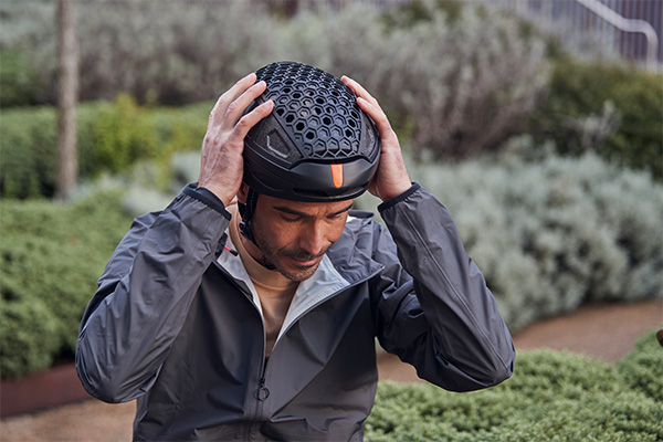 Man putting on newlane helmet