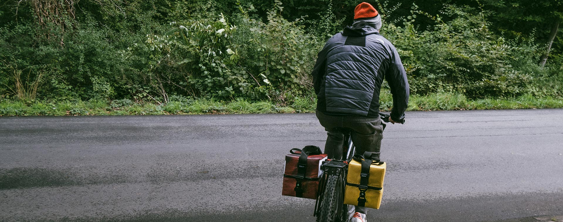Men riding a bike with DJ Oonops Bags
