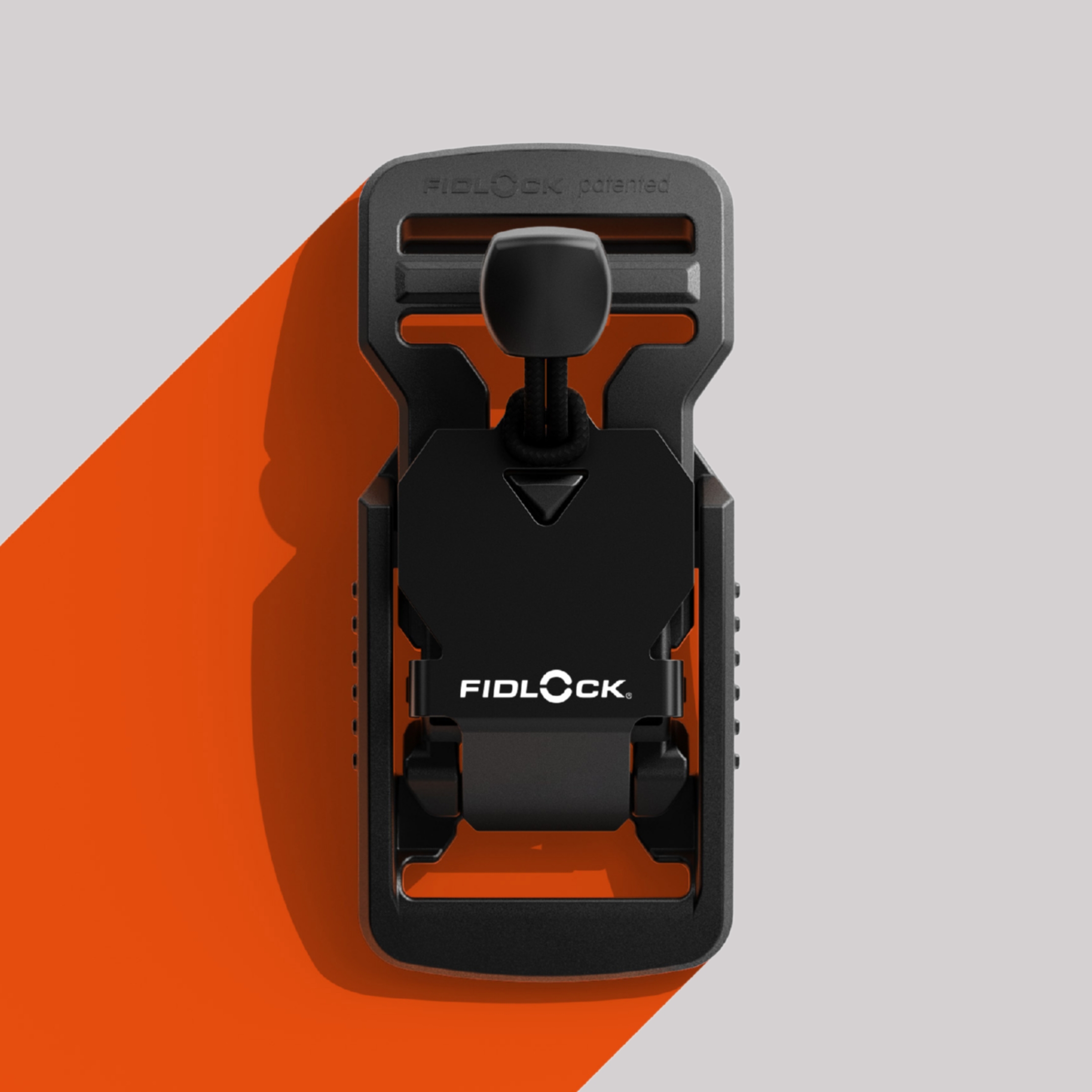 V-BUCKLE in front of grey and orange background