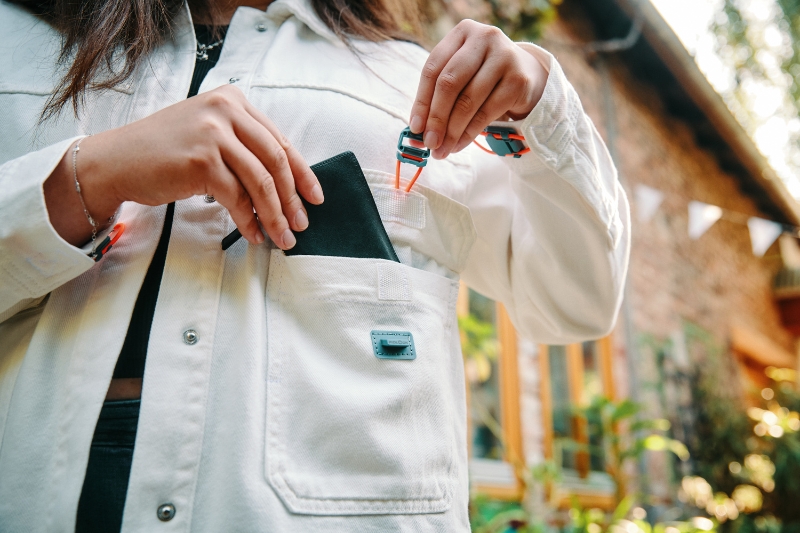 Woman wearing white jacket with recycled FIDLOCK buckles